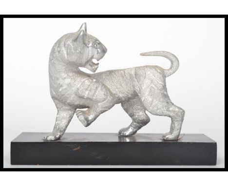 A 20th century silver plated Chinese figurine of a tiger raised on a plinth base. Measures 15 cm high and 20.5 cm wide.
