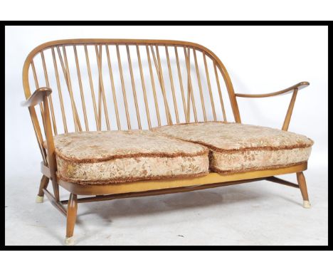 Ercol - A golden dawn Windsor two seater sofa / settee in beech and elm, having the propeller arm rest and spindle back rest.