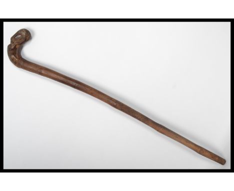 A 19th century bamboo walking stick cane. The handle carved as a dog eating a bird. Please see images. Measures 81 cm high.