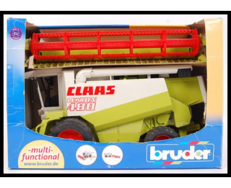 An German made Bruder 1:20 scale Claas Lexion 480 plastic agricultural combine harvester. Within the original box.&nbsp;