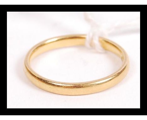 A hallmarked 22ct gold wedding band ring of typical form. Weighs 2.6 grams size K.