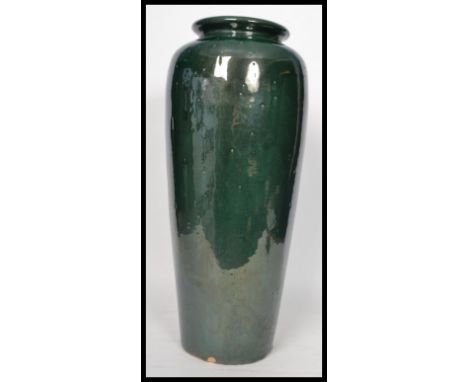 A vintage 20th century large floor standing pottery vase stick umbrella stand having a deep green glaze finish. Measures 61 c