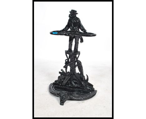 A 20th century cast metal stick stand in the manner of Coalbrookdale having an ebonsied finish with tray below. Measures: 70c