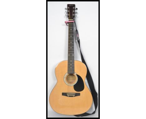 A vintage Elevation six string acoustic guitar having a shaped hollow body with chrome tuning pegs to the head stock.