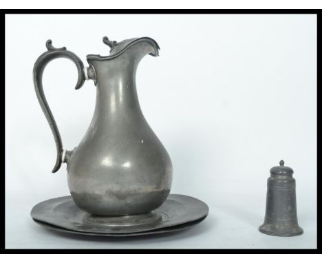 A group of 19th century Georgian pewter wares to include a water jug a pair of circular plates and a writing sander pounce po