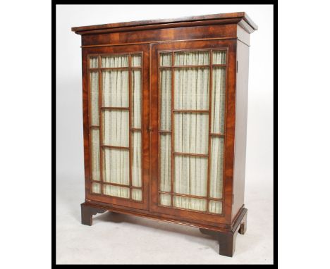 A 19th century Victorian mahogany astral glazed linen backed two door library&nbsp; bookcase. The astral glazed doors are ope