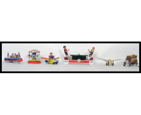 A collection of vintage style clockwork tin plate toys to include ping pong table tennis, vintage bus, rowing boat and steamb