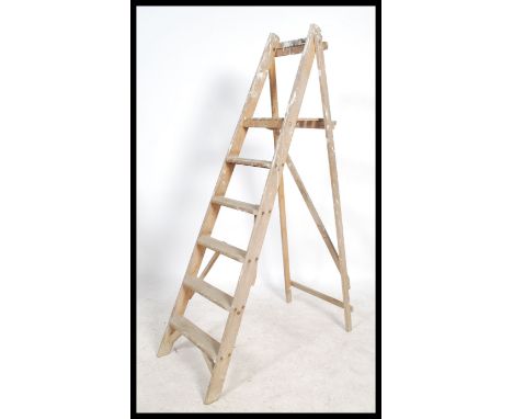 A vintage 20th century&nbsp;Industrial pine wooden step ladder. Of A-frame form having reeded steps and plinth top.