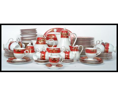 A 20th century Noritake tea service having a red banded border with gilt decoration comprising cups, saucer, plates etc and m