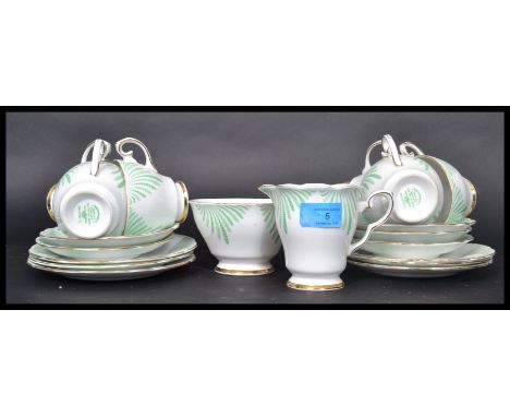 A mid 20th century bone China tea service by Gladstone in the Ferndown pattern consisting off cups, saucers, side plates,crea