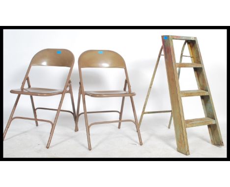 A pair of vintage mid century enamelled metal folding village hall chairs together with a small folding Industrial metal a-fr