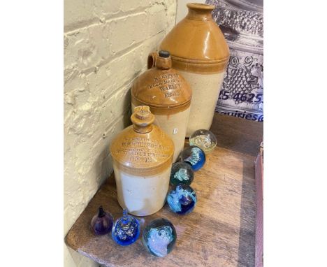 Three Stoneware bottles and seven paperweights including Caithness.