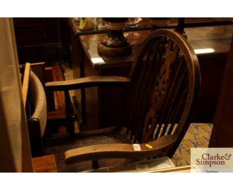 An elm seated stick and wheelback elbow chair; and a Victorian mahogany dining chair 