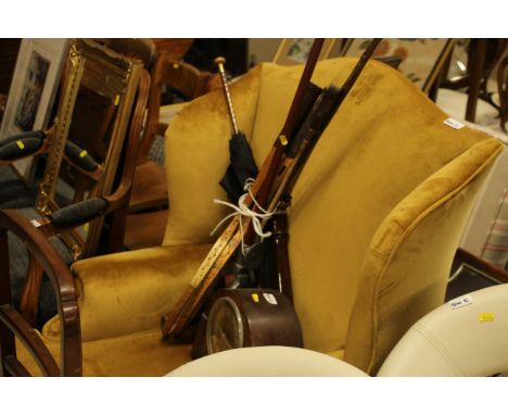 A quantity of walking sticks, tennis rackets, an old mantel clock, truncheon etc. 