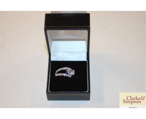 A boxed silver and white stone ring