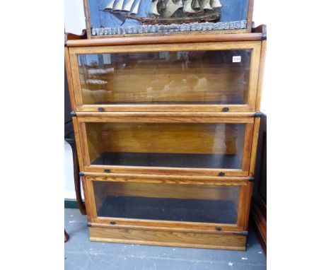 A GLOBE WERNICKE TYPE THREE SECTION OAK BOOKCASE ON PLINTH BASE.   W.87 x H.119 x D.29cms.