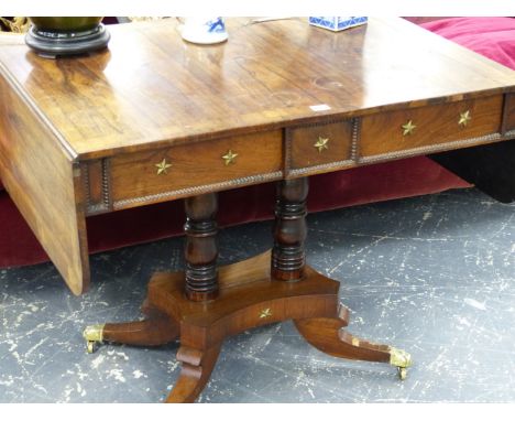 A REGENCY ROSEWOOD AND CROSSBANDED SOFA TABLE ON TWIN CENTRAL COLUMN SUPPORTS AND QUADRUPED SABRE LEGS.   W.143 x D.66 EXTEND