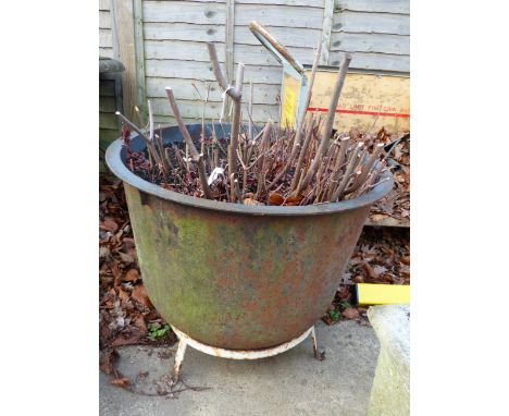 A LARGE CAST IRON COPPER WITH RING STAND.