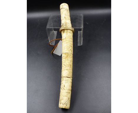 A JAPANESE DAGGER, THE BONE HANDLE AND SCABBARD CARVED IN LOW RELIEF WITH WARRIORS.   L.38.5cms.