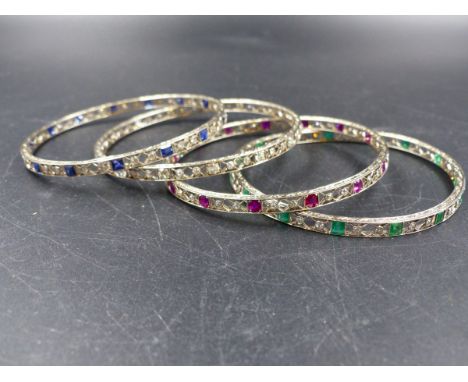 FOUR ART DECO GEMSET BANGLES, EACH ONE HAND MADE IN 18ct WHITE GOLD AND BORDER ENGRAVED . INTRICATELY SET WITH DIAMONDS AND A