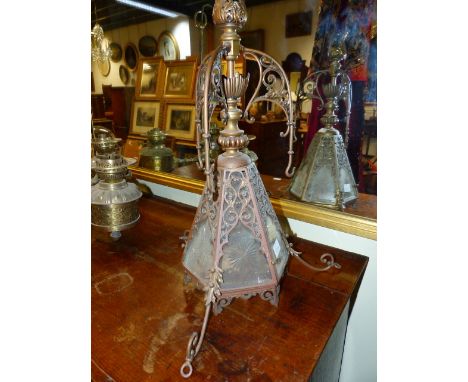 AN ARTS AND CRAFTS HANGING HALL LIGHT FITTING TOGETHER WITH A THREE BRANCH HANGING OIL LAMP FITTING, CONVERTED.  (2)