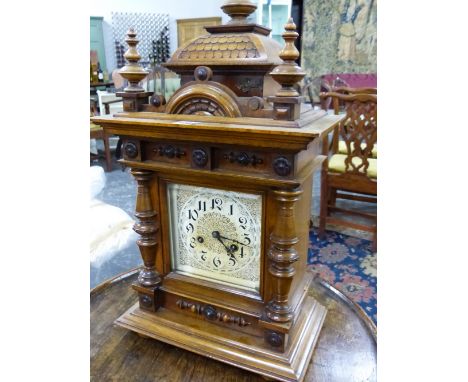 A LATE VICTORIAN WALNUT CASED MANTLE CLOCK WITH PAINTED AND GILT DIAL, GONG STRIKE MOVEMENT.