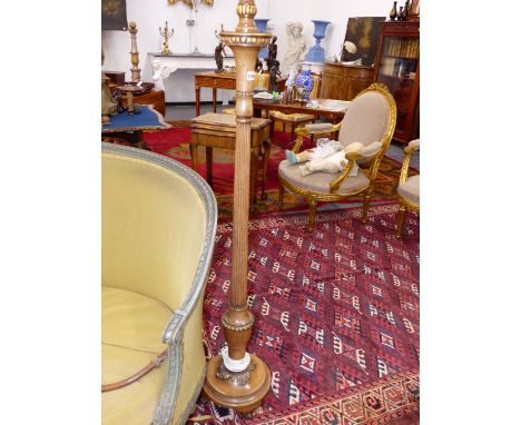 A WALNUT AND GILT DECORATED STANDARD LAMP.