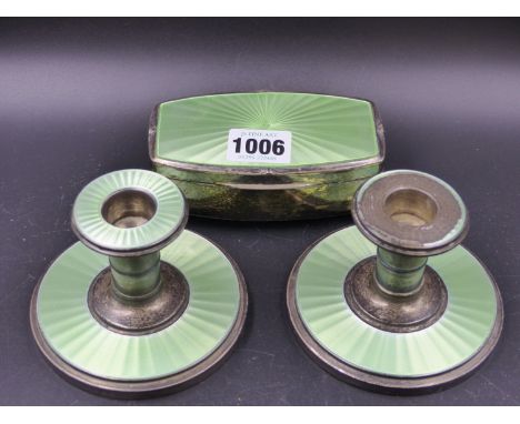 A PAIR OF LIME GREEN ENAMELLED SILVER DWARF CANDLESTICKS TOGETHER WITH A TRINKET BOX BY A C, B'HAM, 1938.  (3)