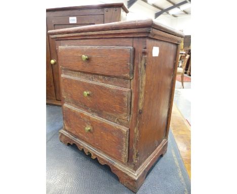 A 19th.C.MINIATURE OAK CHEST OF THREE DRAWERS ON SHAPED BRACKET FEET.   H.34cms.