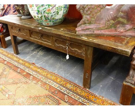 A CHINESE CARVED LOW THREE DRAWER  SCROLL TABLE.   W.191 x H.53cms.