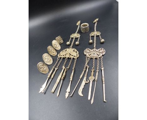 TWO ORIENTAL WHITE METAL CHATELAINES WITH IMPRESSED CHARACTER MARKS TOGETHER WITH FIVE FIGURALLY DECORATED RINGS AND A FURTHE