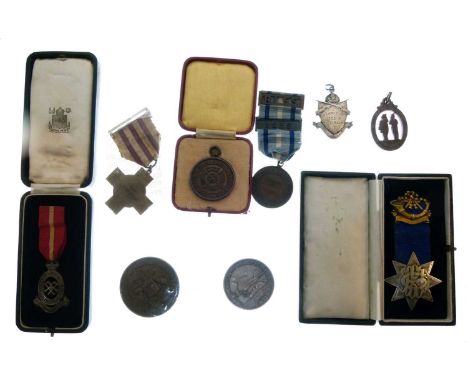 Quantity of cased badges/jewels and medallions to include; silver 'Poly Rifle Club' fob, silver Territorial Army Nursing Serv