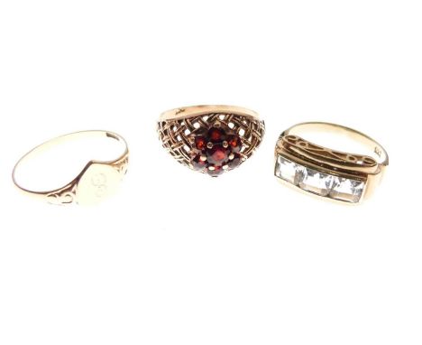 9ct gold heart-shaped signet ring, size R, a garnet cluster ring stamped '9ct', and an unmarked dress ring set three pale blu