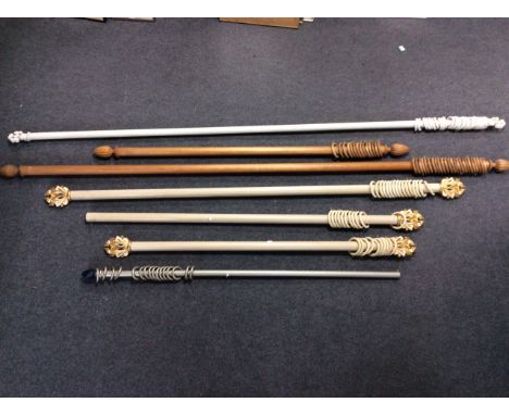 Three cream and gilt painted curtain poles one with single finial, 225cm, 160cm and 177cm, a pair of wooden curtain poles, 28