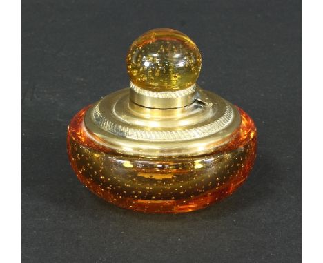 A Whitefriars controlled bubble amber glass inkwell, of squat circular form with brass mounts, 10cm diameter