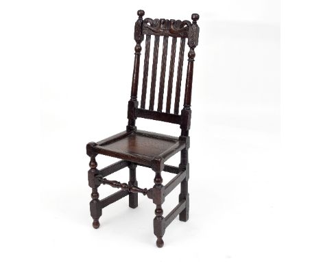 A Charles II oak side chair with conjoined dolphins carved to the crest, solid seat and on turned and block supports/see illu