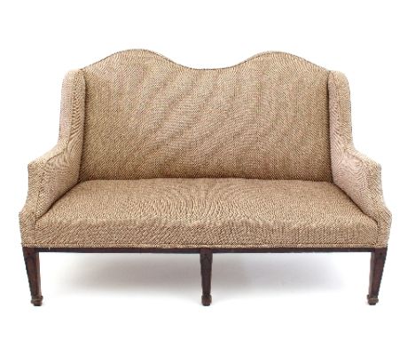 A 19th Century mahogany framed arch back sofa, the upholstered back and seat on three square tapering front legs, 136cm wide/