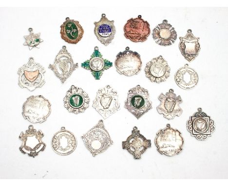 A quantity of silver medallions of Irish Dancing interest, Dublin hallmarks, mainly 1940's - 1950's, some with enamel decorat