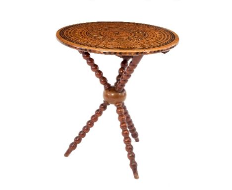 An inlaid Gypsy table, the circular top inlaid concentric bands of decoration on a tripod base, 56cm diameter/see illustratio