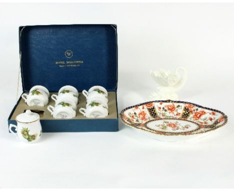 A Royal Worcester scallop shell dish with dolphin support, 10cm high, a Royal Crown Derby floral dish and a box of Royal Worc