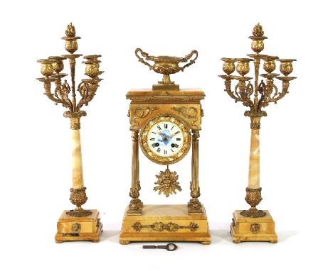 A late 19th Century clock set, the base and top in variegated marble with gilt metal mounts and column supports, fitted a cir