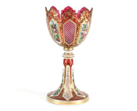 A Bohemian red glass vase, decorated white overlay panels of flowers and with gilt scrolls throughout, 36.5cm high/see illust