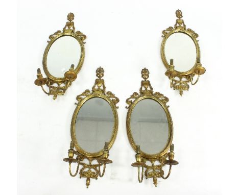 Four oval gilt metal wall mirrors each with twin light to the base, 70cm high