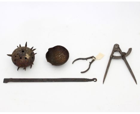 A pierced and spiked iron ball possibly from a ball and chain, a steel compass, a nut cracker and an iron ladle (handle detac