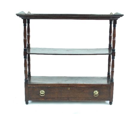 A George III oak two-tier hanging wall shelf with turned supports and single drawer, 88cm wide