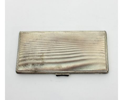 A silver cigarette case of rectangular form with all over engine turned decoration, stamped Sterling 925
