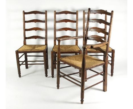 Four ladder back chairs with rush seats, comprising three singles and one carver