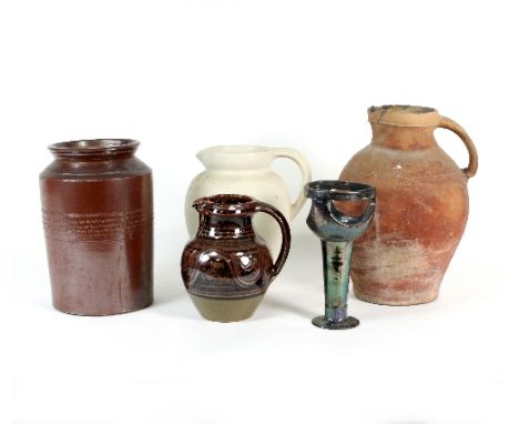 A Winchcombe pottery jug with stylised decoration to a brown glaze, 19.5cm high, two further jugs, a stoneware jar, all unmar