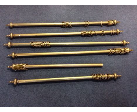 Six gilt painted curtain poles, each with turned finials, 203cm, 210cm, 148cm (with only one finial), 205cm, 196cm and 205cm