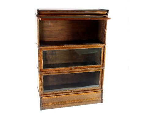 A Globe Wernicke type oak bookcase of three sections, each with rising glazed door, on a plinth base, 125cm high, 87cm wide